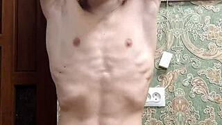 skinny boy flexes his muscles in underwear at home