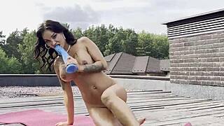 Is Monika Fox fucking her ass and pussy with a dildo on the roof?