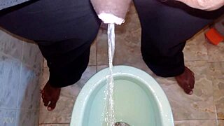 Boy takes a quick pee while the black man handles his own pissing moment outdoors.