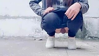 Chinese crossdressing ladyboy masturbates outdoors in stockings during midday urge.