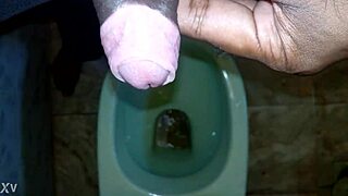 Boy takes a quick pee while the black man handles his own pissing moment outdoors.