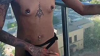 kashofficials bends over on the balcony getting strapped doggystyle by renity love with ebony lesbian strapon action and tight pussy riding in public