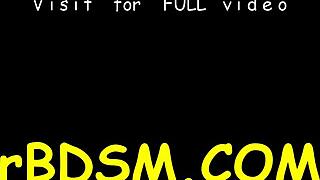 Stuffing brunette girl with hard toy in BDSM slave fetish session.