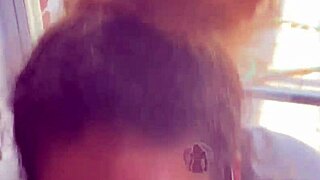 In a homemade setup, lightskin ebony slut gives blowjob to big black cock friend by the window and takes facial cumshot.