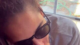 In a homemade setup, lightskin ebony slut gives blowjob to big black cock friend by the window and takes facial cumshot.