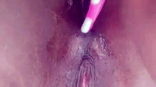 ebony performer inserts a brush into her anus for pleasure