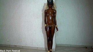 she showcases her shiny black body glistening with oil on her tits in a solo display