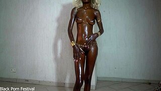 she showcases her shiny black body glistening with oil on her tits in a solo display