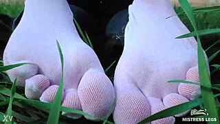 Goddess Feet in Cute White Socks and Jeans on Spring Grass Field