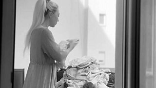 Naked chubby woman with big tits hangs laundry on balcony for neighbors to watch