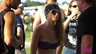 Rock fest flashers show off sexy moves behind the scenes at daytime party.