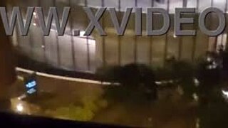 Petite amateur babe masturbating clit close up in public outdoor spot in front of hotel window to orgasm