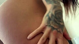 sultry tattooed brazilian milf fists her huge ass in black bodysuit closeup