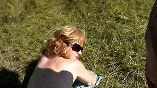 A pervert spots beautiful sexy blonde sunbathing naked on wild beach and jerks off publicly.