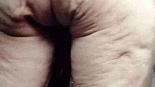 Granny rams cucumber deep into hairy pussy